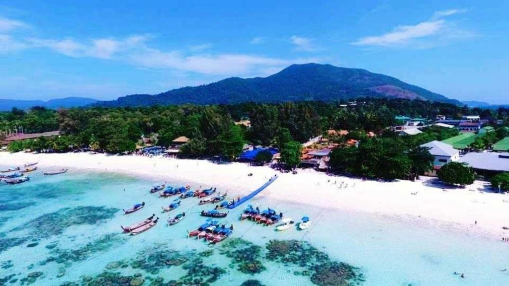 an aerial view of a beach with boats in the water at Charming Lipe Beach Resort in Ko Lipe