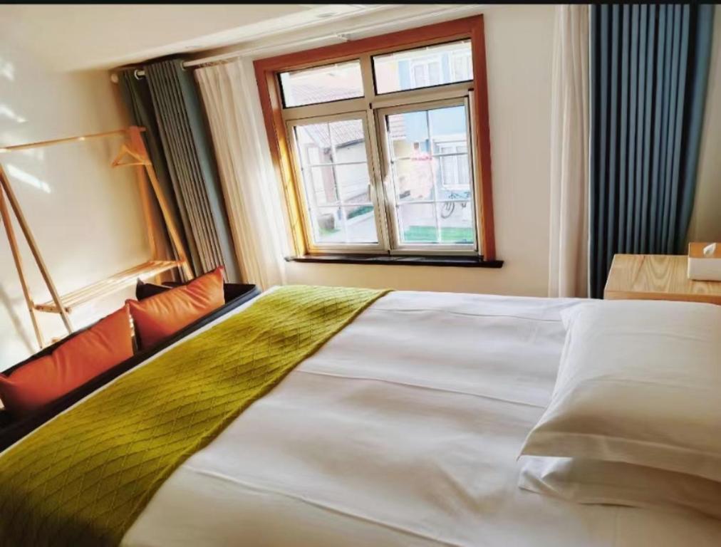 Postel nebo postele na pokoji v ubytování Shushe Hotel Shanghai