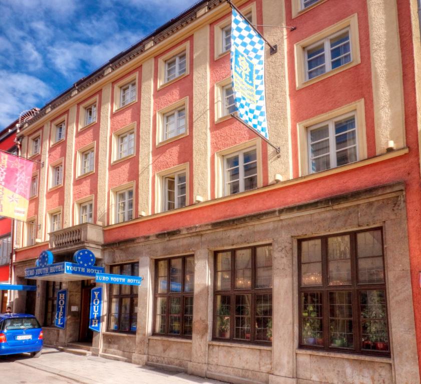 a building with a flag on top of it at Euro Youth Hotel Munich in Munich