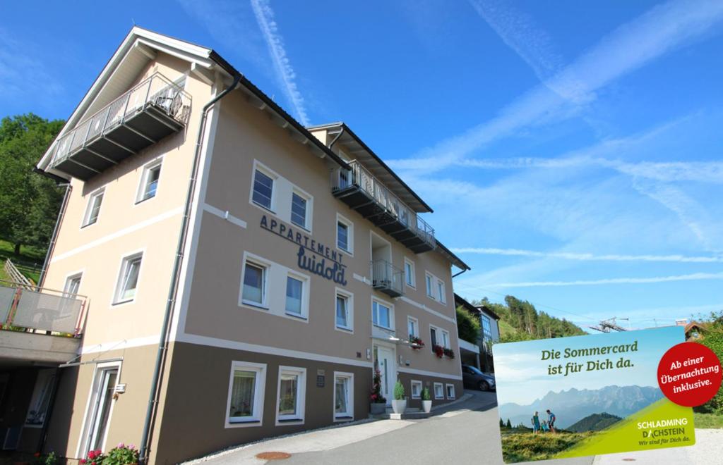 a building with a sign in front of it at Apartments Luidold in Schladming