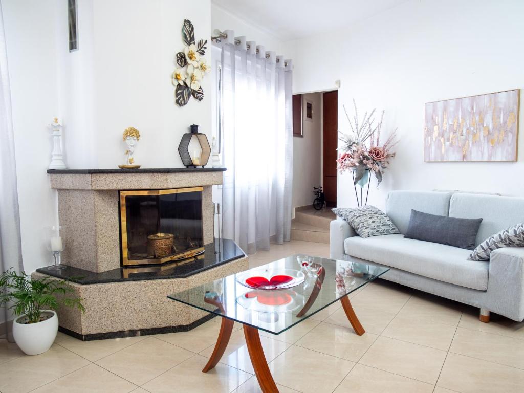 a living room with a couch and a fireplace at Rena's House in Ierapetra