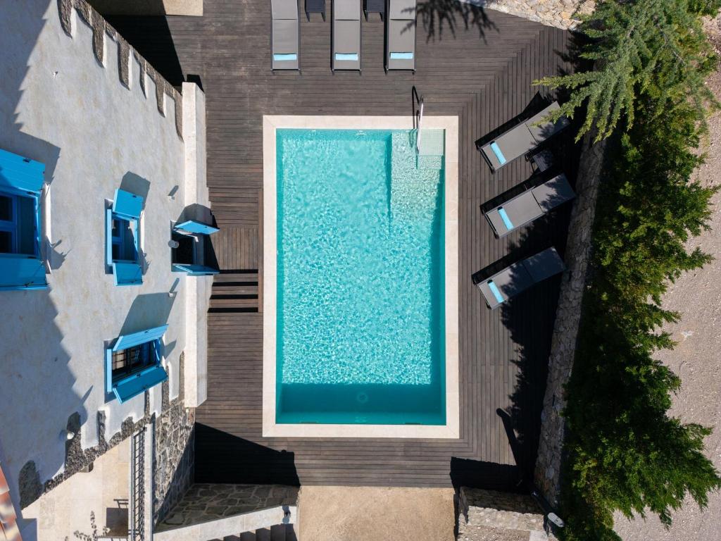 an overhead view of a swimming pool next to a building at Luxury Villa Ive With Heated Pool, Finnish Sauna, Infrared Sauna, Pet Friendly in Krk