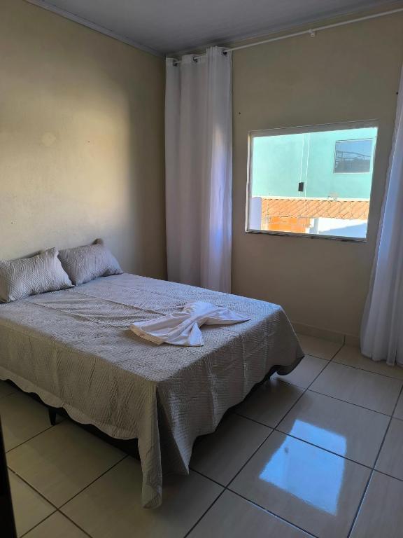 a bedroom with a bed with a towel on it at Apartamento completo in Montes Claros