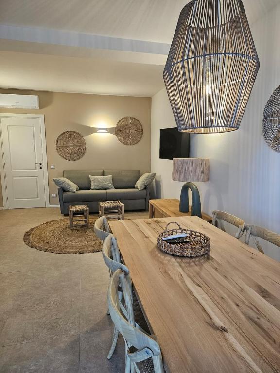 a living room with a wooden table and a couch at Padre Relais di Campagna in Collemezzano