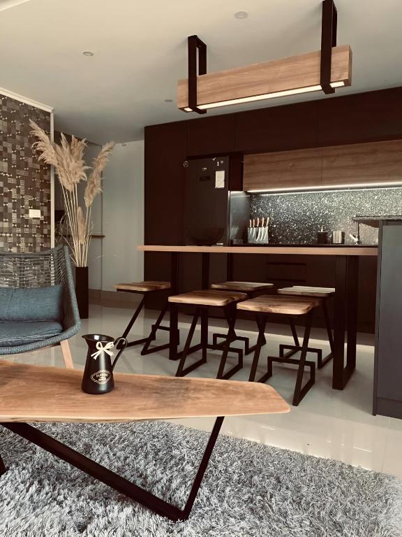 a kitchen with wooden tables and chairs in a room at Aqua Blue Lakeview Apartment Ohrid in Peštani