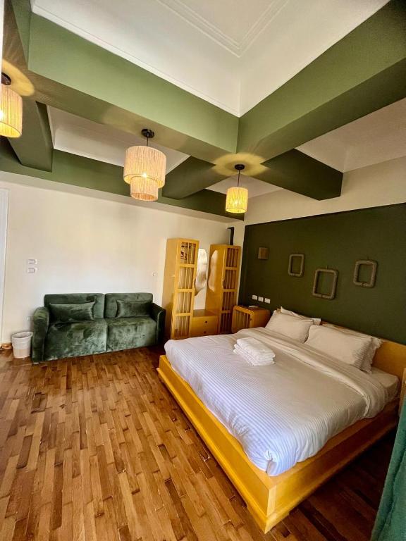 a bedroom with a large bed and a couch at Town View Studios in Cairo