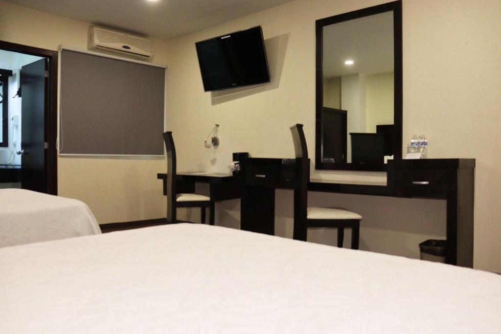 Postel nebo postele na pokoji v ubytování Wyndham Garden Aguascalientes Hotel & Casino