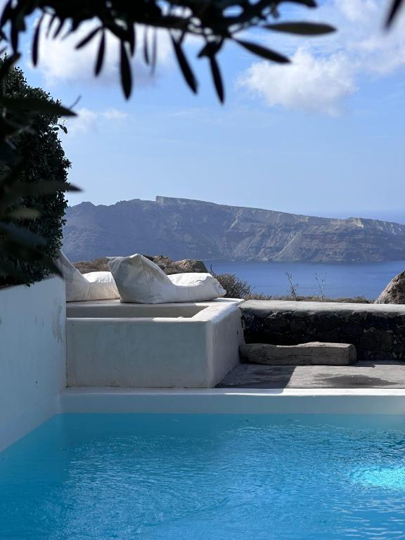 a swimming pool with a view of the water at 270 Oias View in Oia