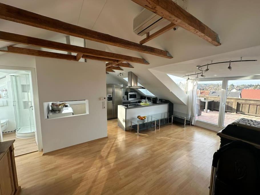 a large room with a kitchen and an attic at Helles, modernes Appartement in Nuremberg