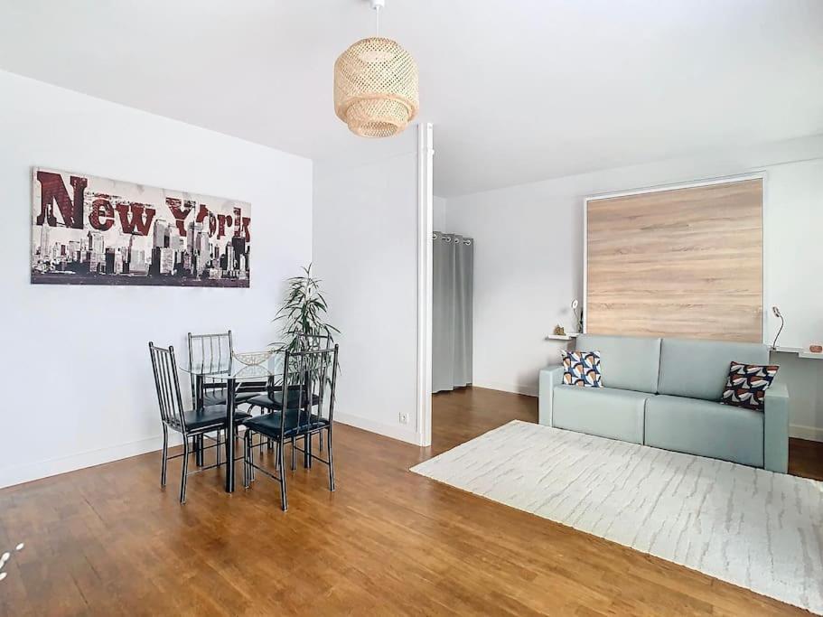 un salon avec un canapé, une table et des chaises dans l'établissement Appartement à 15 minutes de Paris et Parc Expositions de Villepinte de CDG, à Aulnay-sous-Bois