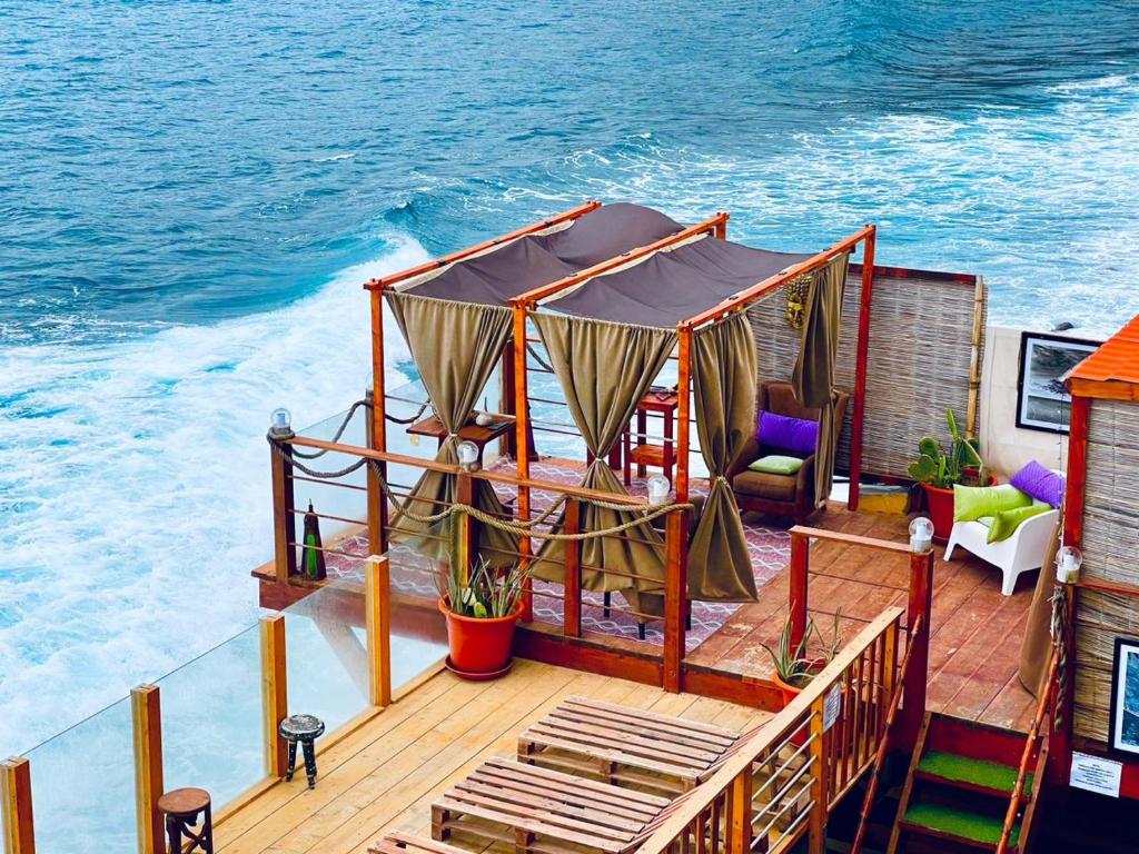 a boat deck with a gazebo on the water at Tienne Del Mar in Paul
