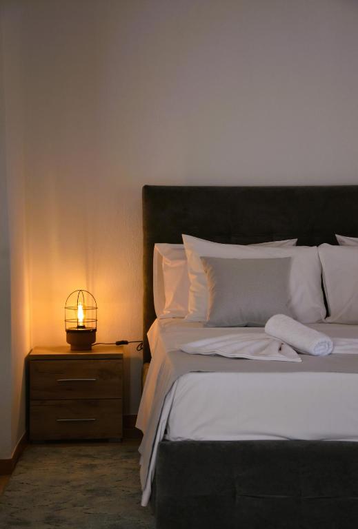 a bedroom with a bed with a lamp on a night stand at Casa Valesa in Skala Sotiros