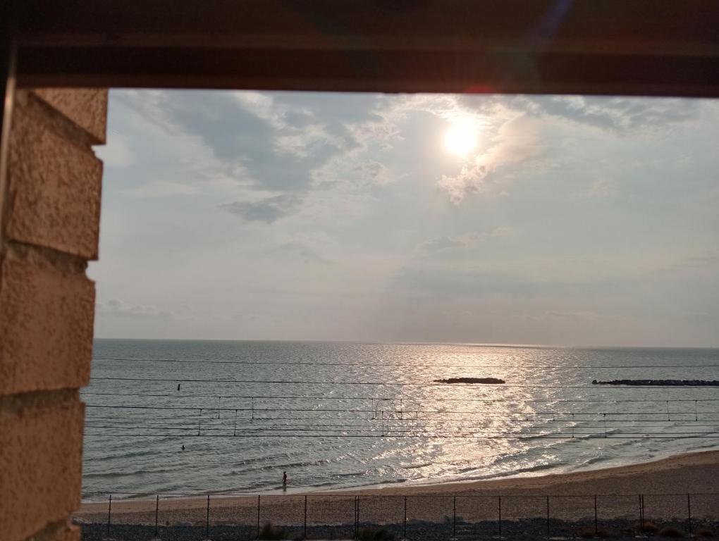 a view of the ocean from a window of a beach at Case Vacanze Colombo in Civitanova Marche