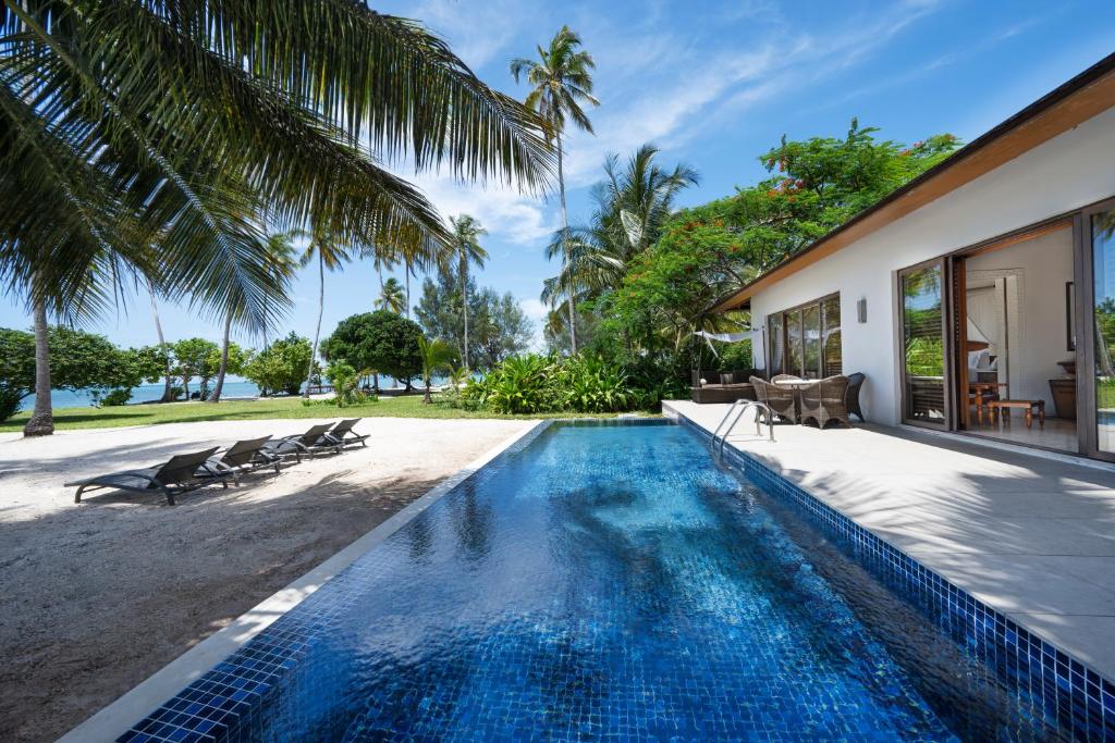 an infinity pool in the backyard of a villa at The Residence Zanzibar in Kizimkazi