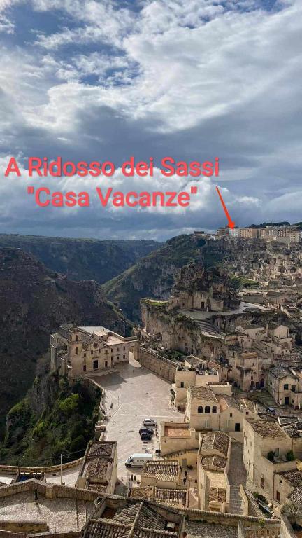a view of a city with a red arrow saying a rueblos del s at A Ridosso dei Sassi in Matera