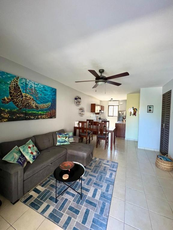 a living room with a couch and a table at Sea Bottom Ground Condo in Coco