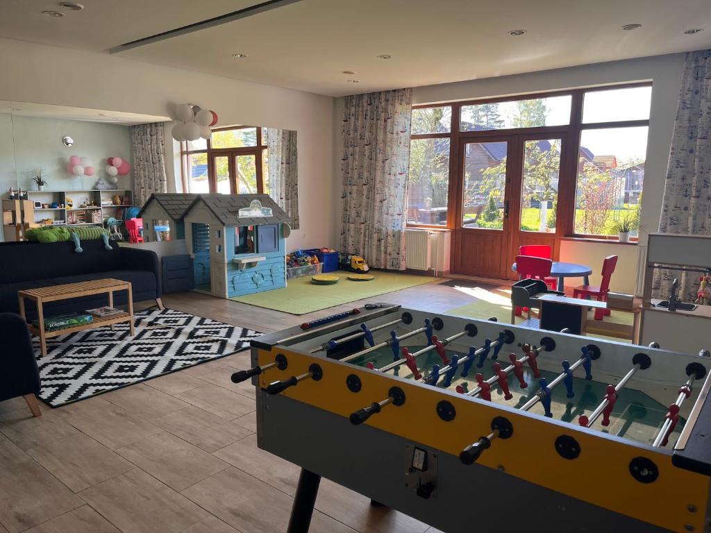 a living room with a foosball table in the middle at SKiPER Dębki in Dębki