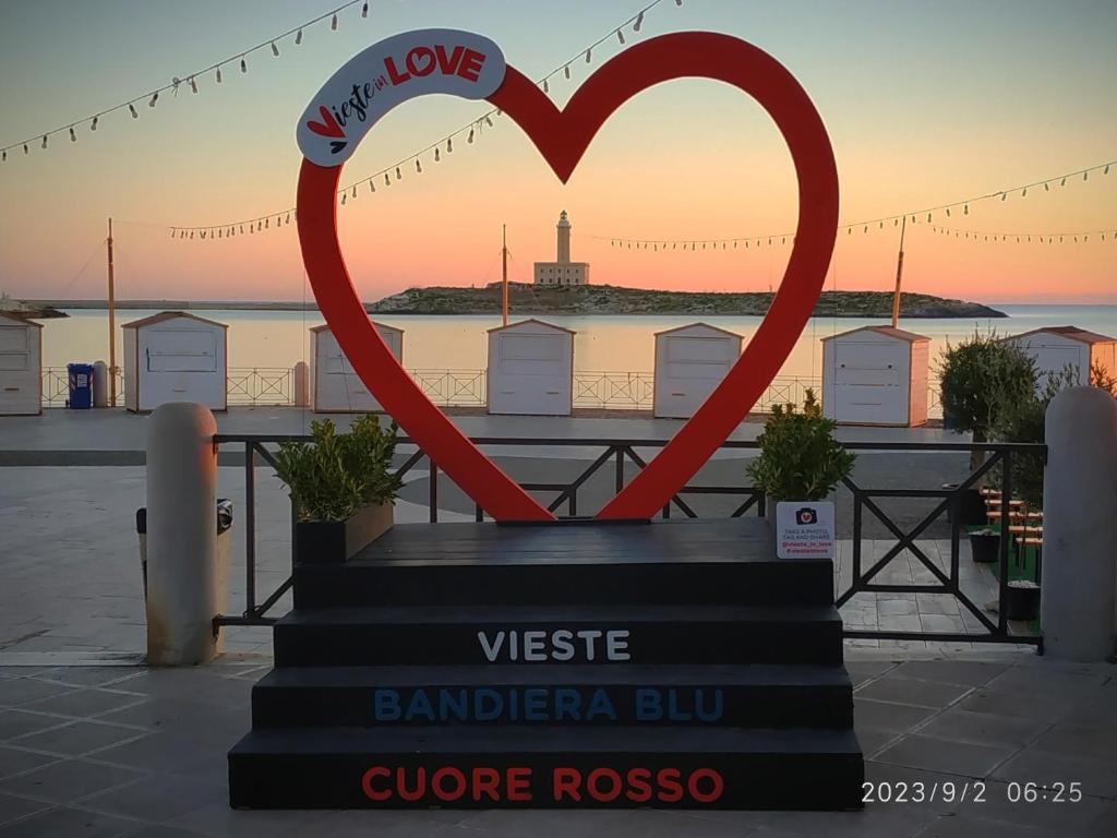 a statue of two hearts in front of a sunset at Villa Scialara in Vieste