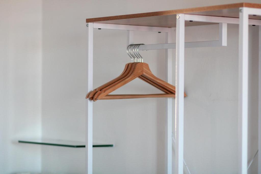 a closet with a wooden hanger in a room at Flaminio Luxury Home - City Center in Rome