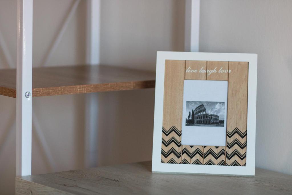 a picture frame sitting on top of a table at Flaminio Luxury Home - City Center in Rome