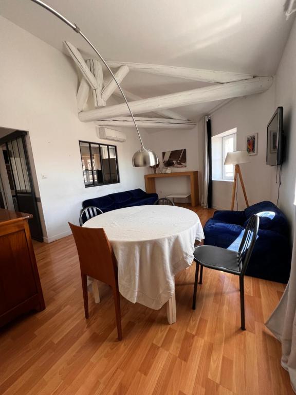 un salon avec une table et un canapé bleu dans l'établissement 18 Rue Général Périer, à Nîmes