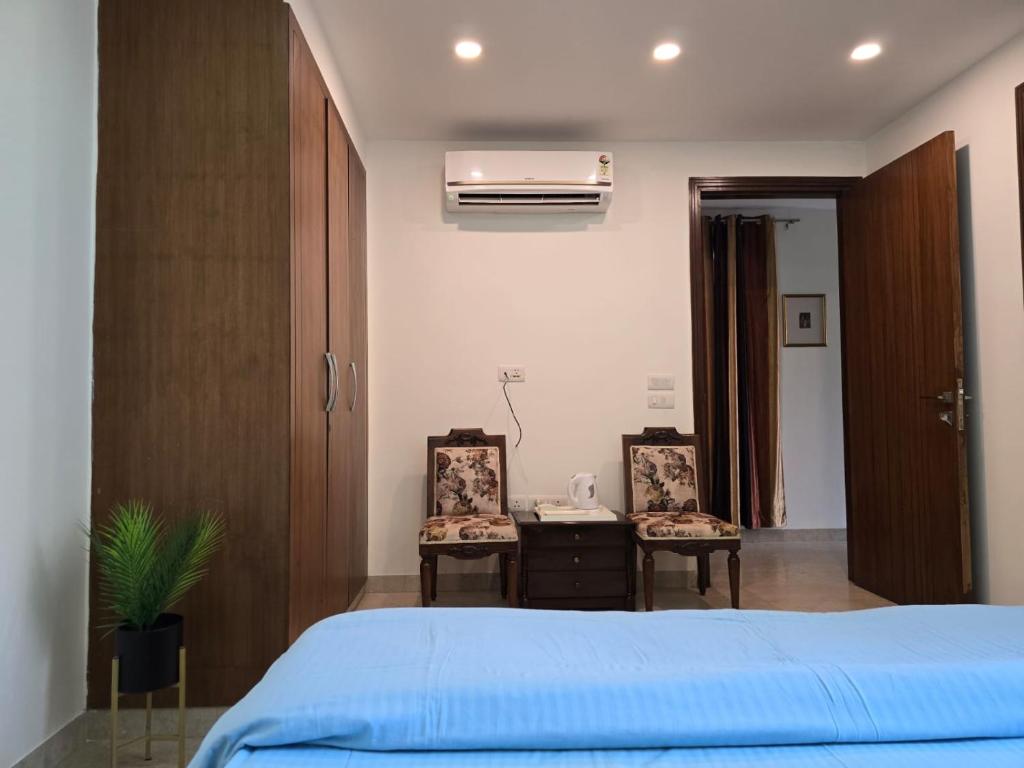 a bedroom with a blue bed and a desk at Two Green Park in New Delhi