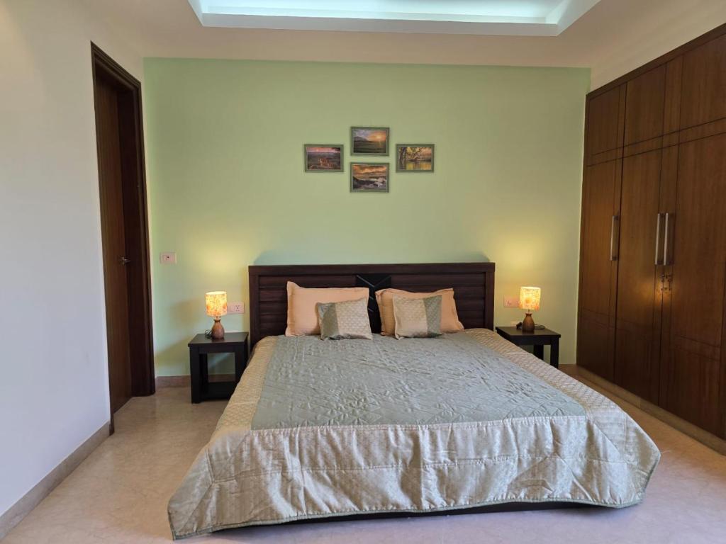 a bedroom with a large bed with two night stands at Two Green Park in New Delhi