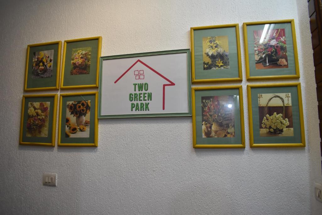 a group of framed pictures on a wall at Two Green Park in New Delhi