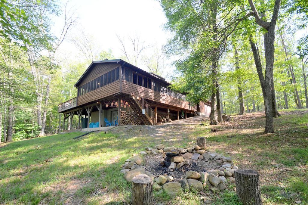 a wooden house on a hill with a fire pit at Ahh ... Riverwood in Morton Grove