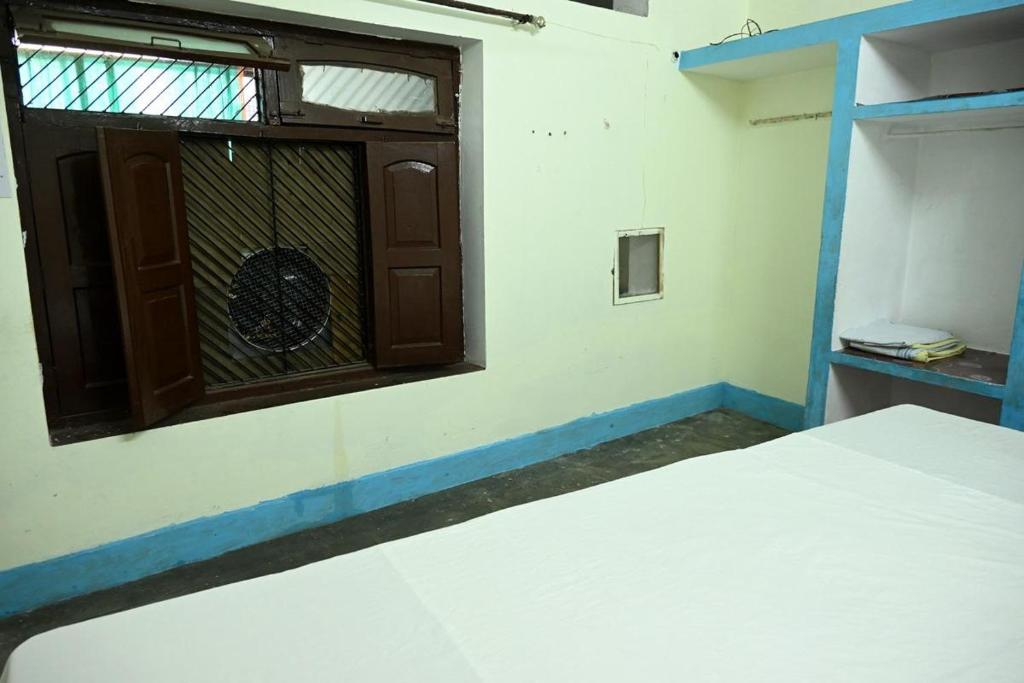 Voodi või voodid majutusasutuse Sandhya Guest House toas