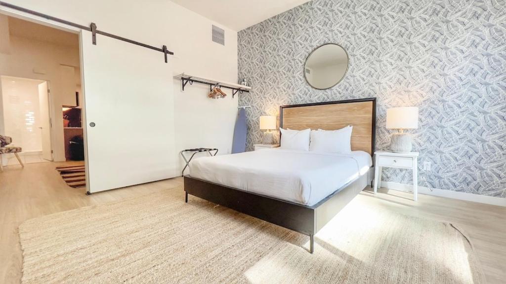 Un dormitorio con una cama y un espejo en la pared. en Executive Escape In Downtown San Diego, en San Diego