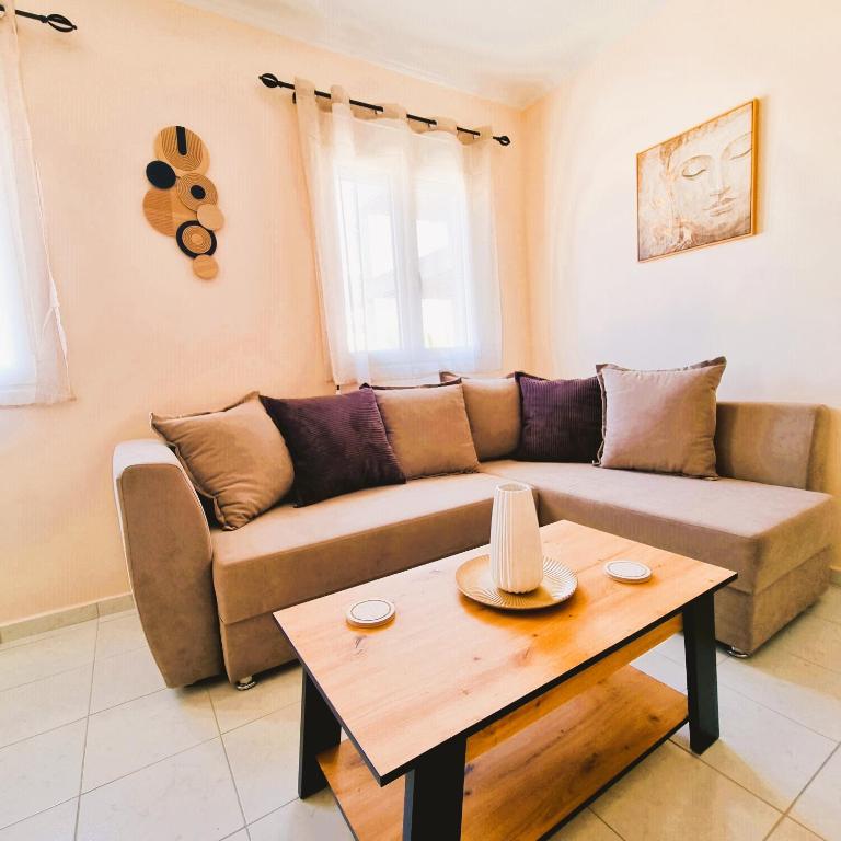 a living room with a couch and a coffee table at Estrella Apartment in Sparta