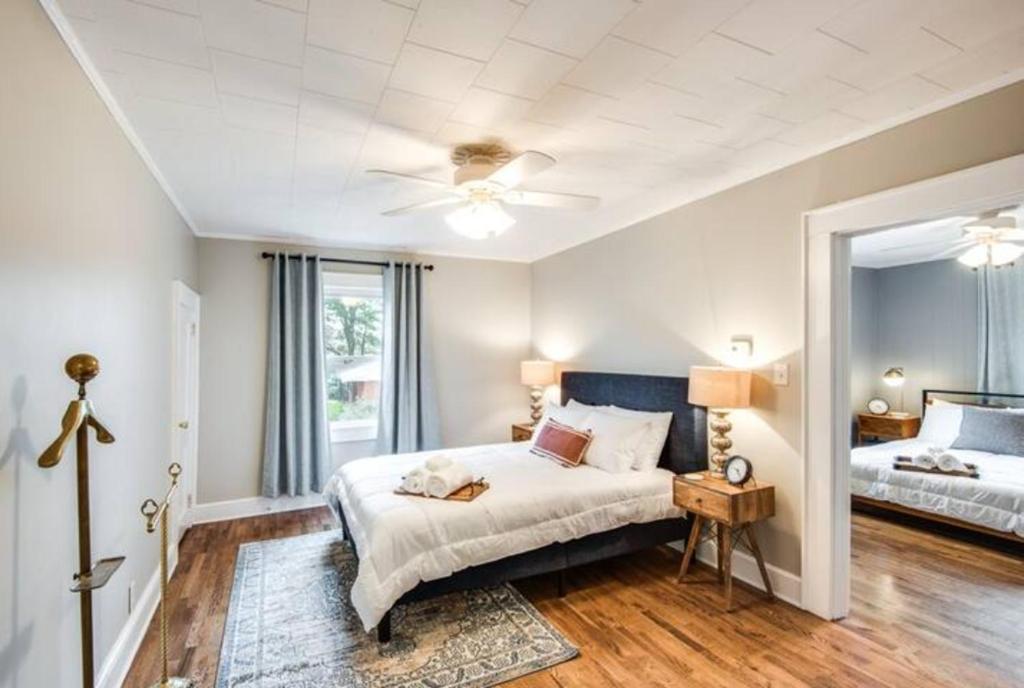 a bedroom with a bed and a large mirror at Southern Charm Cottage in Hickory