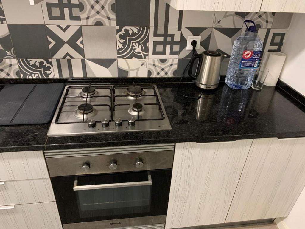 una cucina con piano cottura e forno di Spacious Bedroom In a Modern T3 Apartment a Costa da Caparica