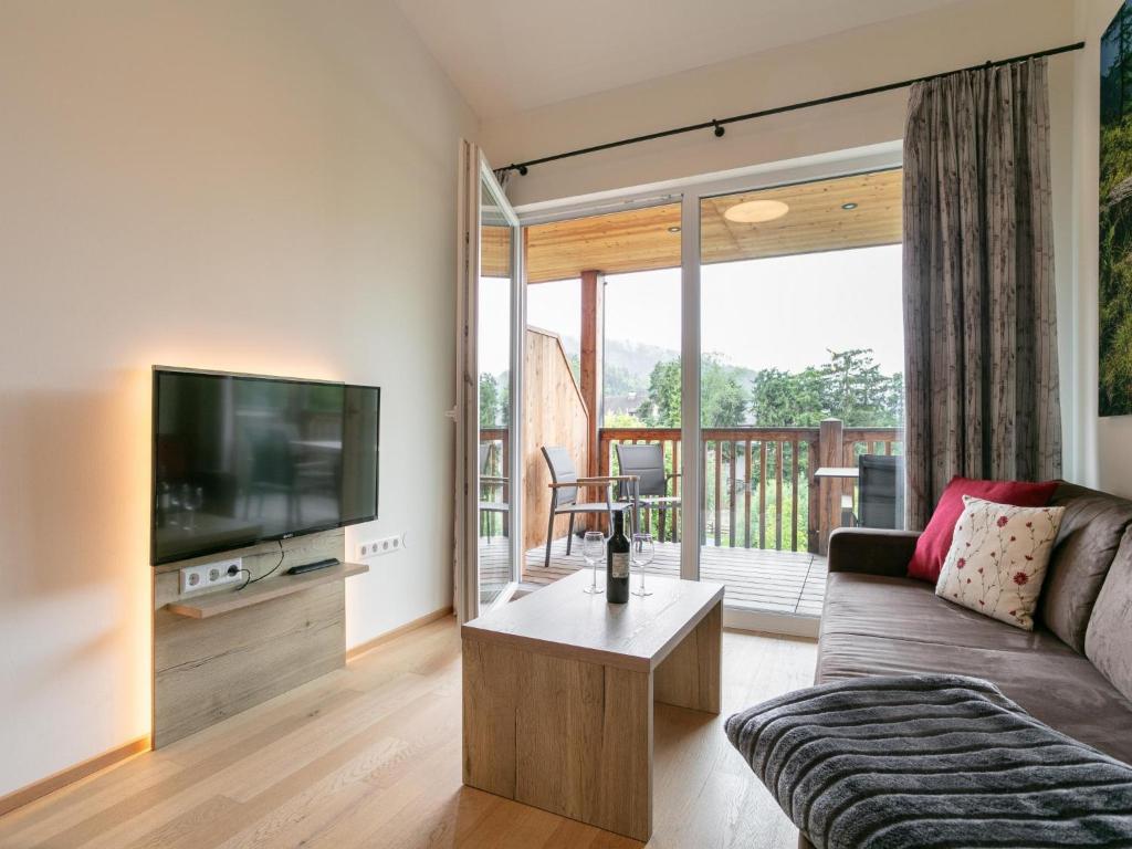 a living room with a couch and a flat screen tv at Apart33 Top 2-16 in Haus im Ennstal