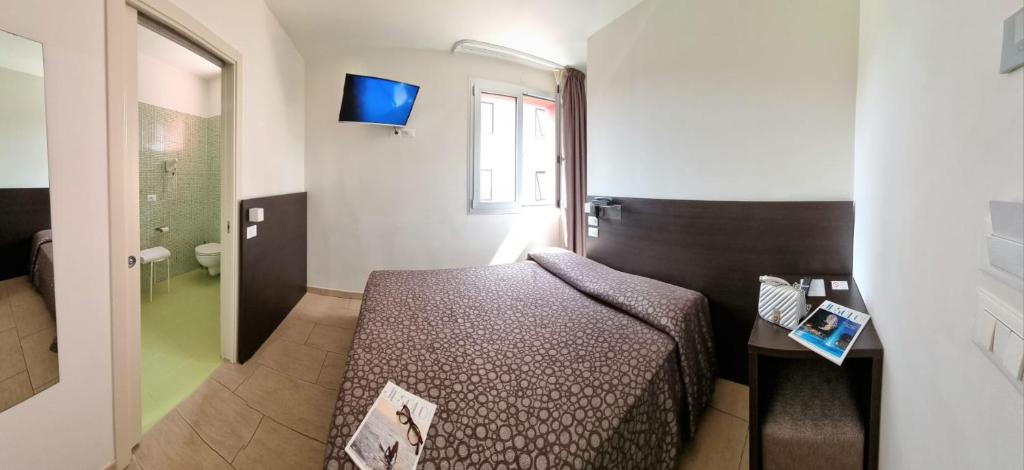 mały pokój z łóżkiem i łazienką w obiekcie Hotel Morena w mieście Lido di Jesolo