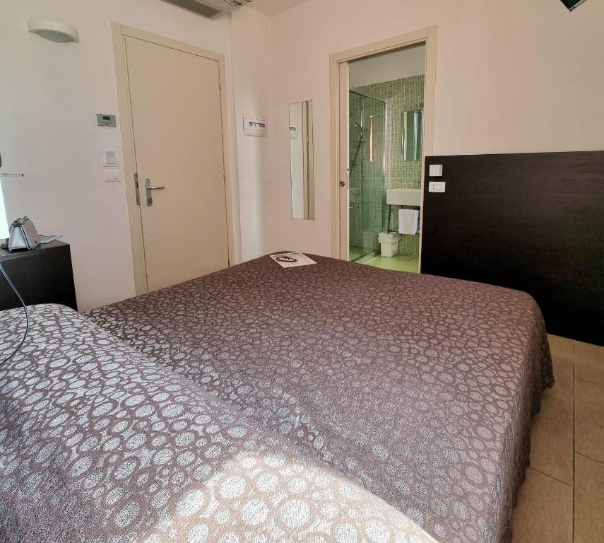Łóżko lub łóżka w pokoju w obiekcie Hotel Morena