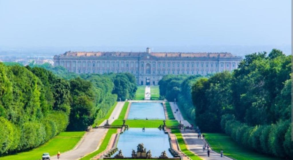 a view of a large building with a lake in front at B&B merilyn house in Caserta