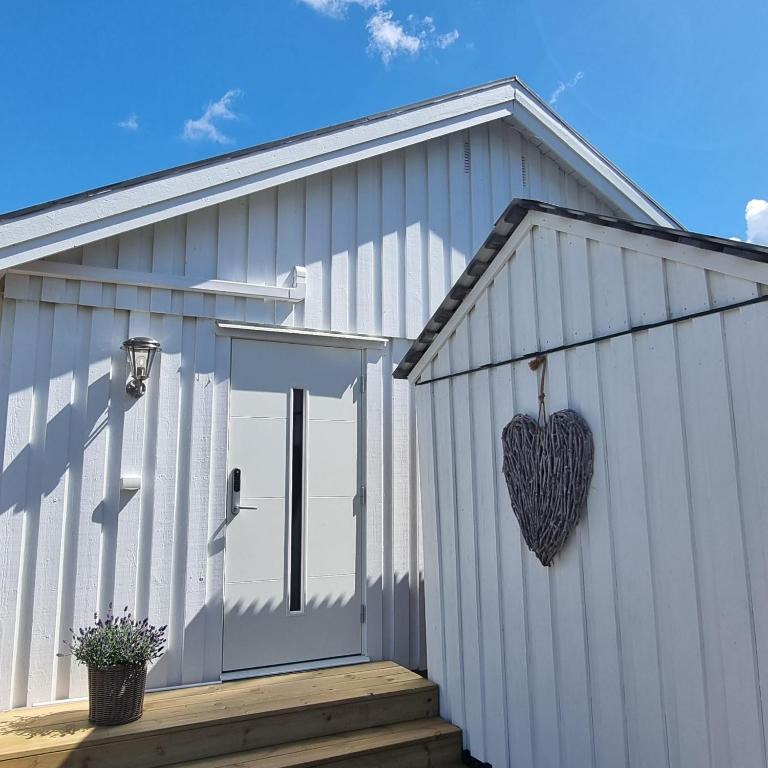 a heart hanging on the side of a building at Gäststuga i historiska Gamla Uppsala in Uppsala