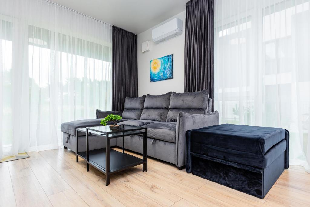 a living room with a couch and a table at SUN HOME in Palanga