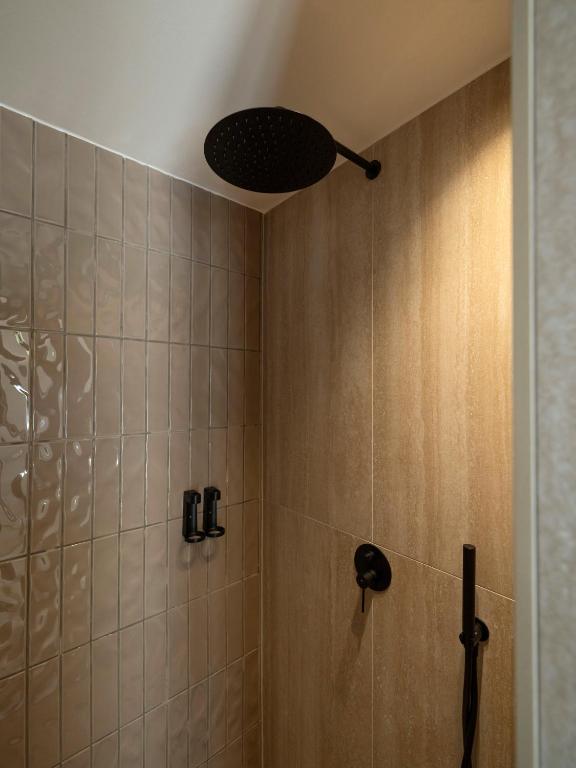 a bathroom with a shower with a shower head at Anemelia way of living in Naousa