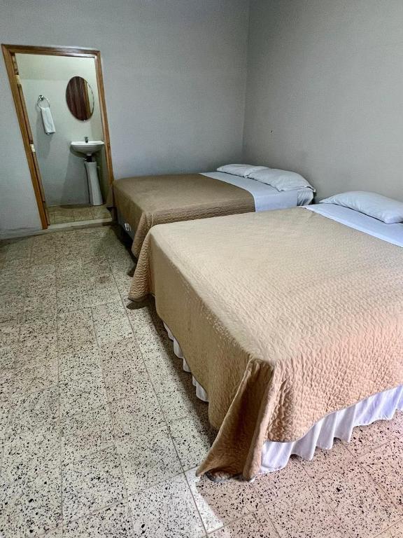 Postel nebo postele na pokoji v ubytování Aparta Hotel Palmerola