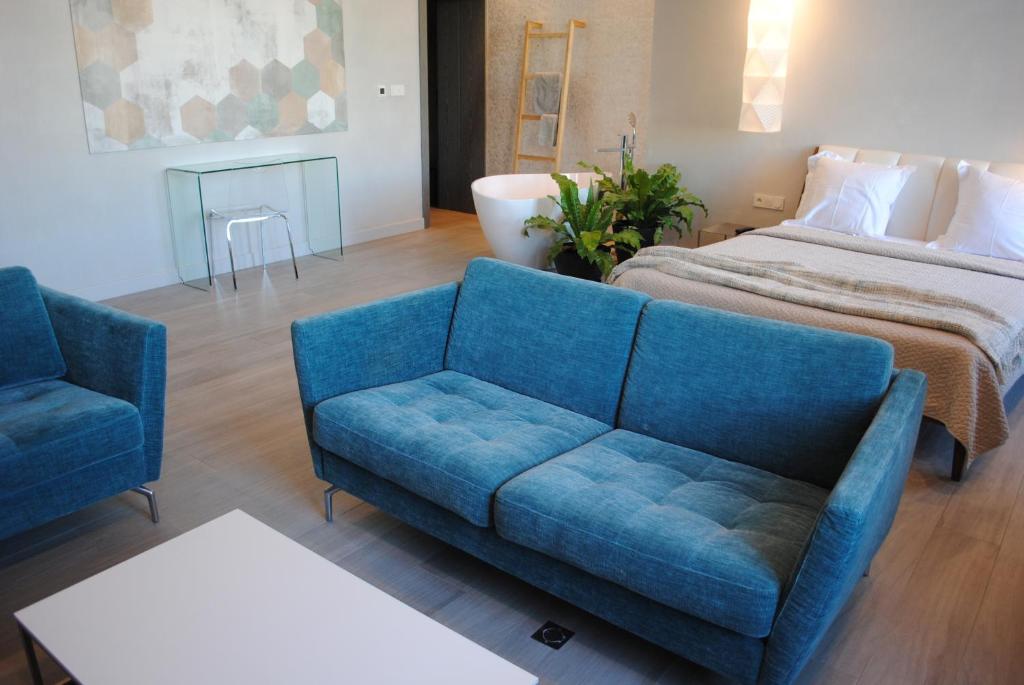 a living room with a couch and a bed at Les Suites Massena in Nice