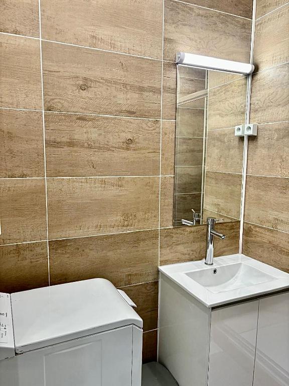 un bagno con un water, un lavandino e uno specchio di Guest House Tour Eiffel Paris a Parigi
