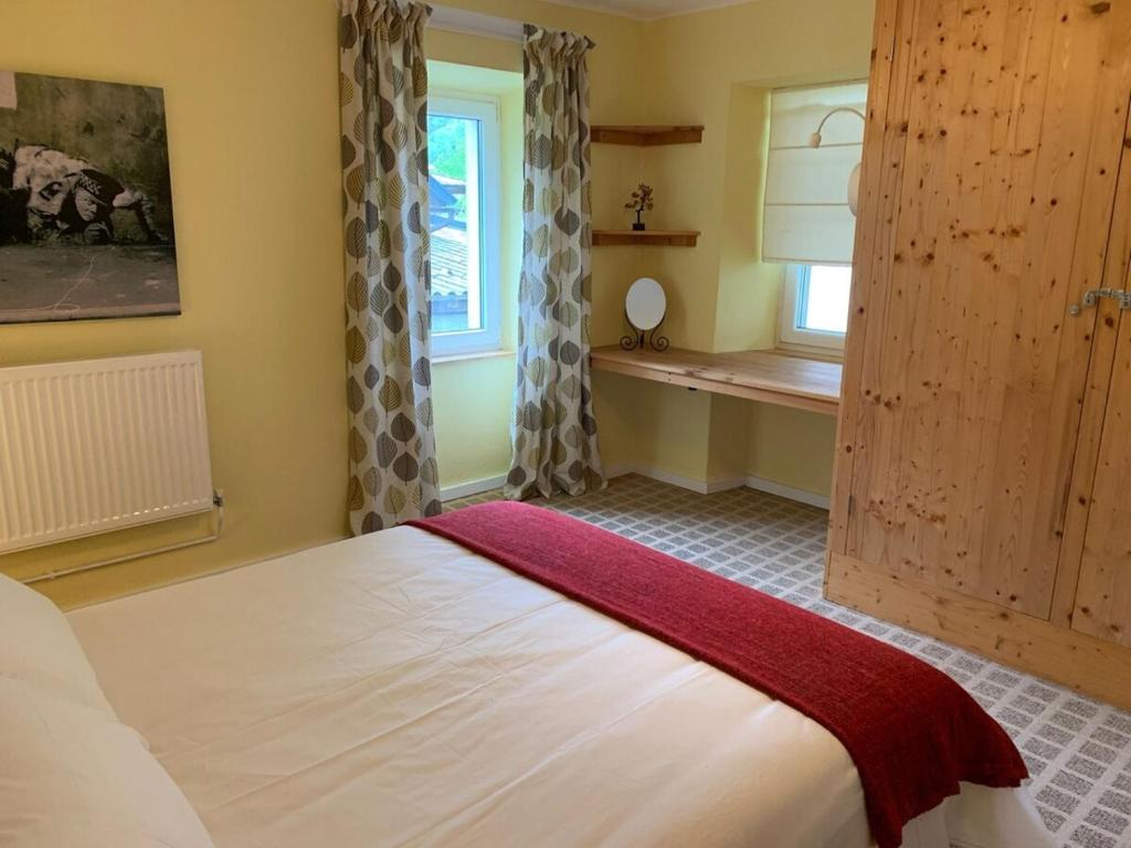 a bedroom with a large bed and a window at Apartment Yiorgos in Bovec