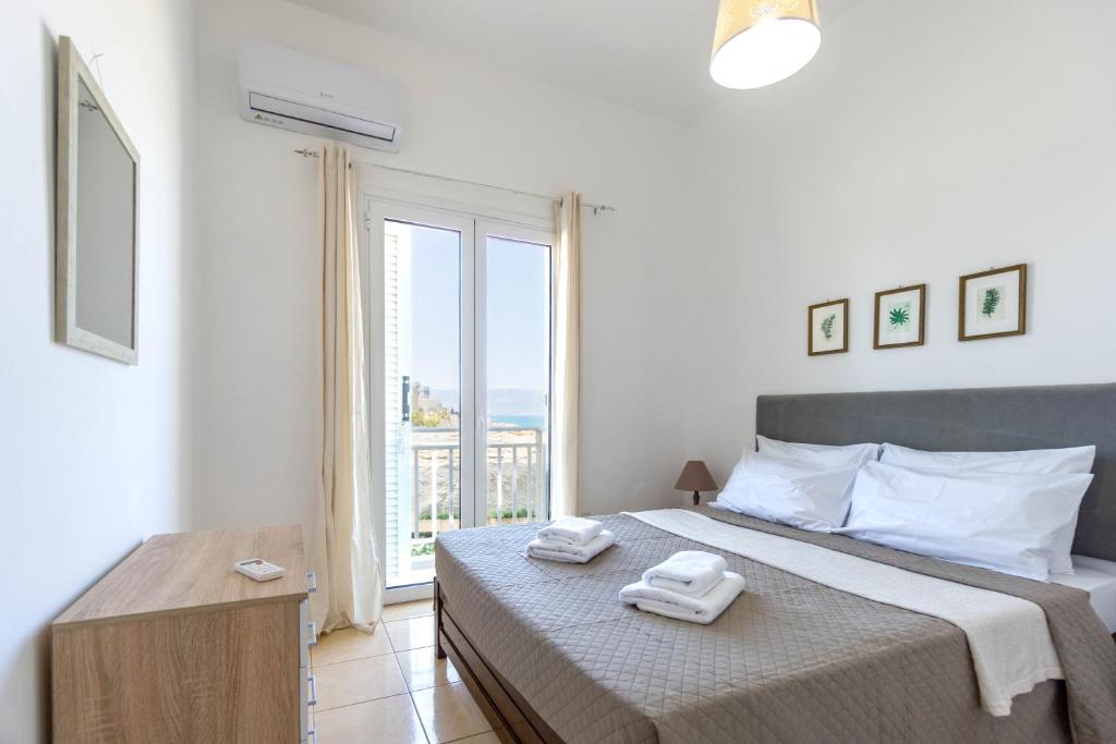 a bedroom with a bed with two towels on it at Spacious seaview apartment in Heraklion in Heraklio