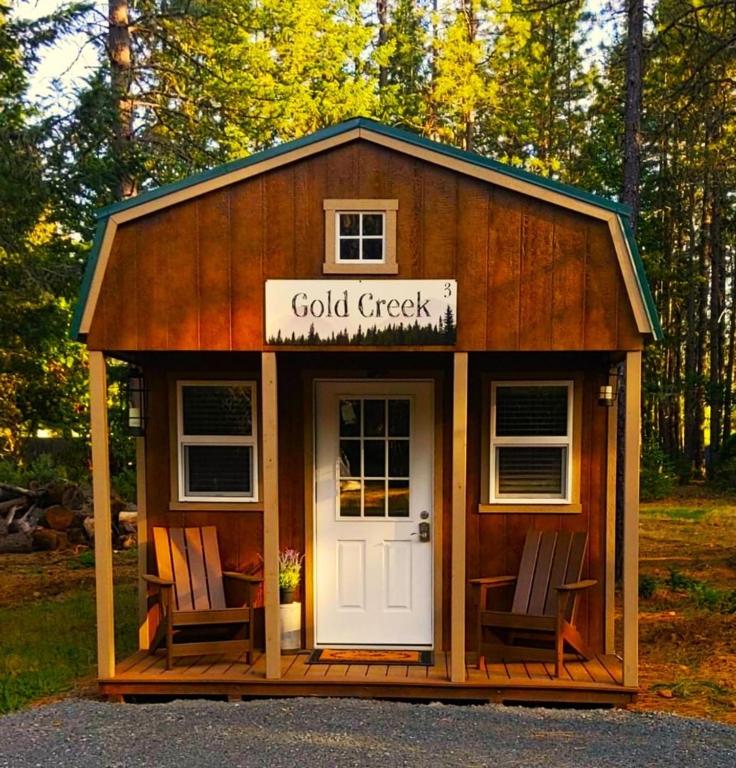 a small cabin with two chairs in it at Gold Creek Cabin 3 - Sleeps up to 4 in O'Brien
