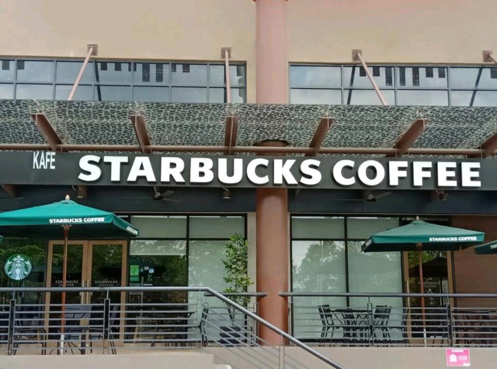 a starbucks coffee sign on the front of a building at 2 Bedrooms Suites at Mesahill Nilai with Mall by D'KAY HOMES, near USIM KLIA in Nilai