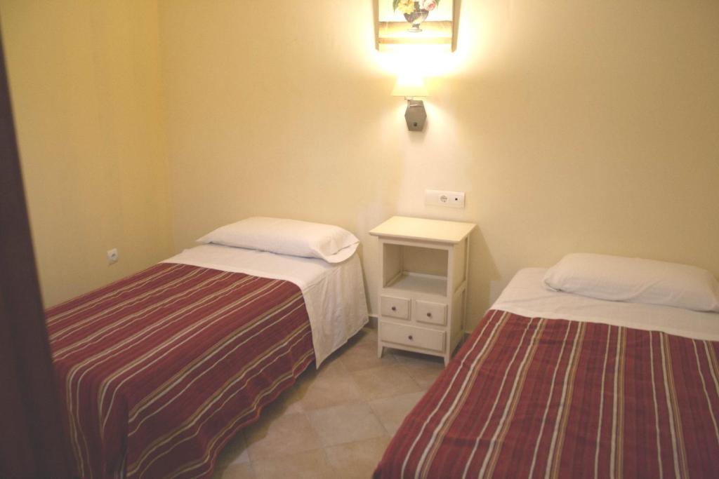Postel nebo postele na pokoji v ubytování Abadia Suites