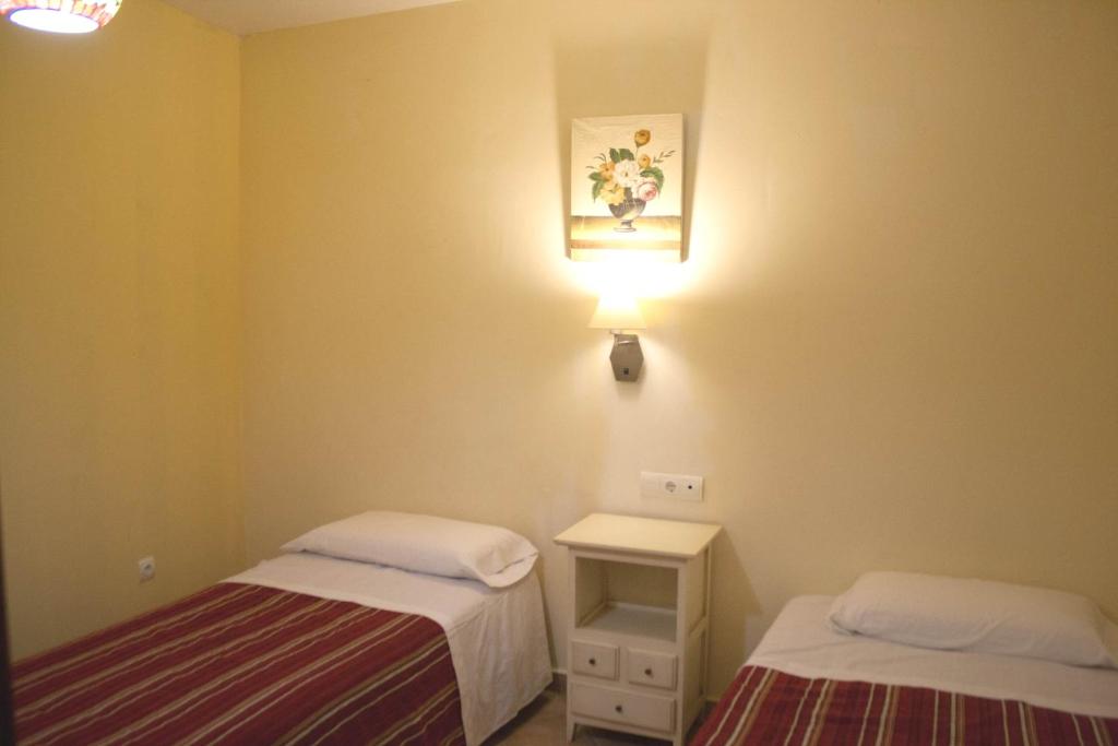 Postel nebo postele na pokoji v ubytování Abadia Suites